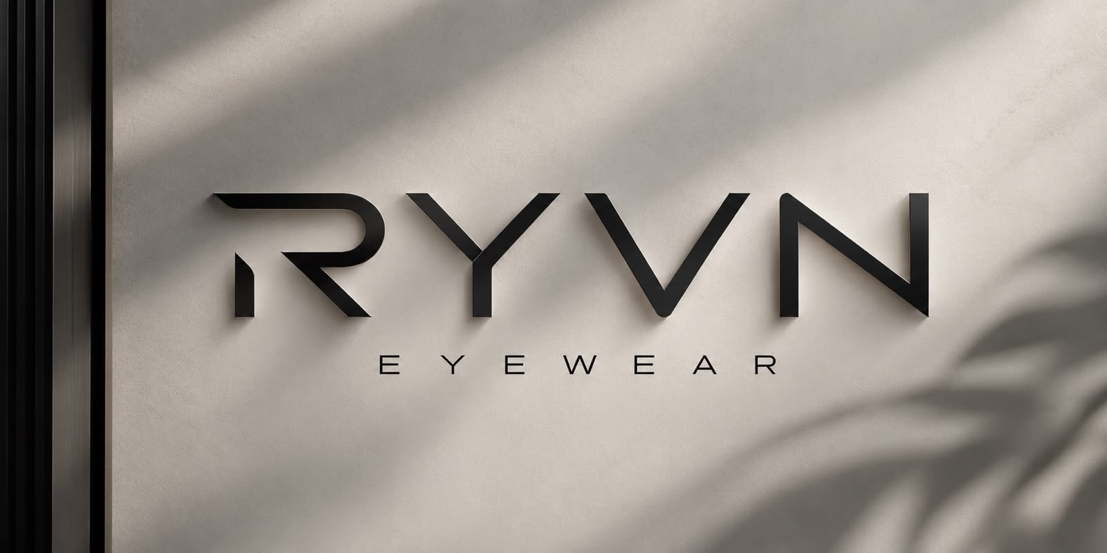 The RYVN Eyewear wordmark, mounted in cut lettering on a stone wall